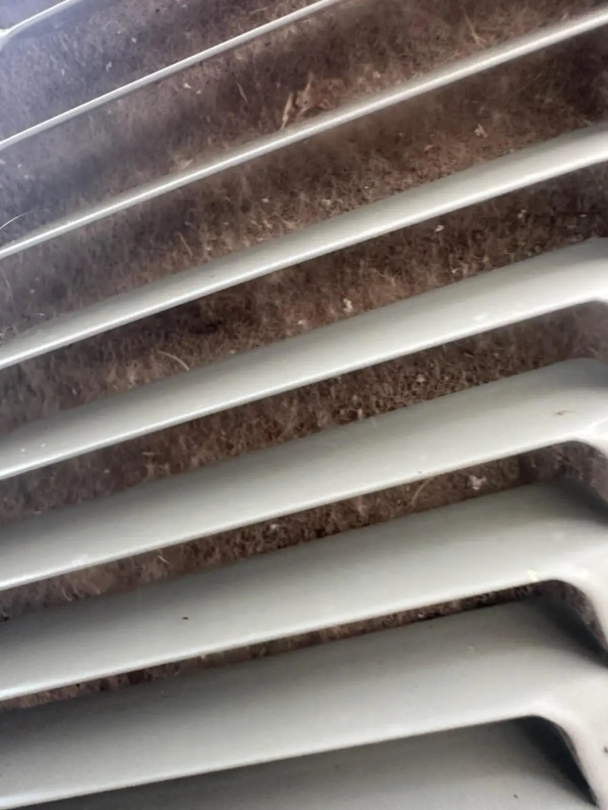 Dirty air conditioner condenser coil requiring professional AC maintenance in Claremore Oklahoma